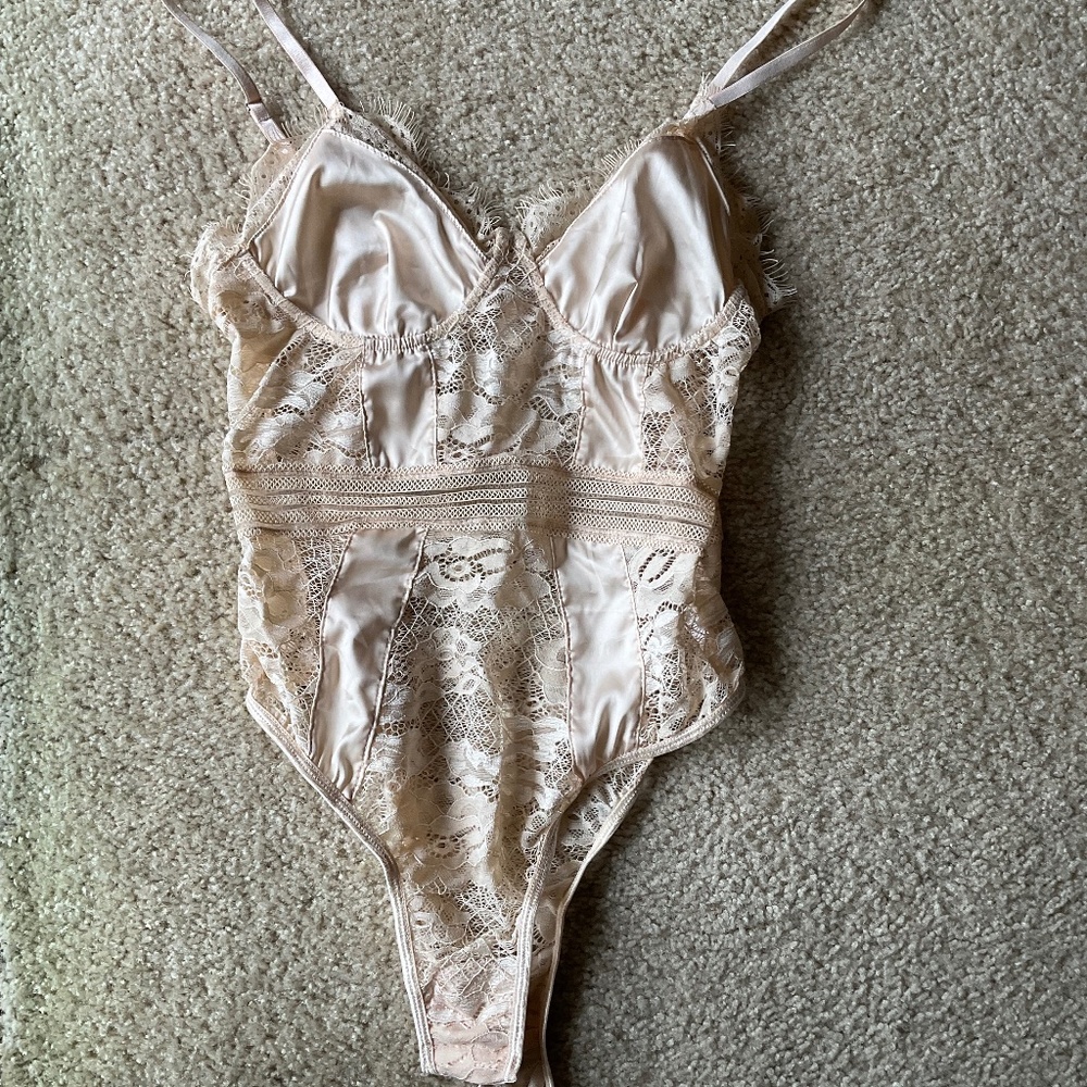 Cream lingerie bodysuit with buttons on the bottom